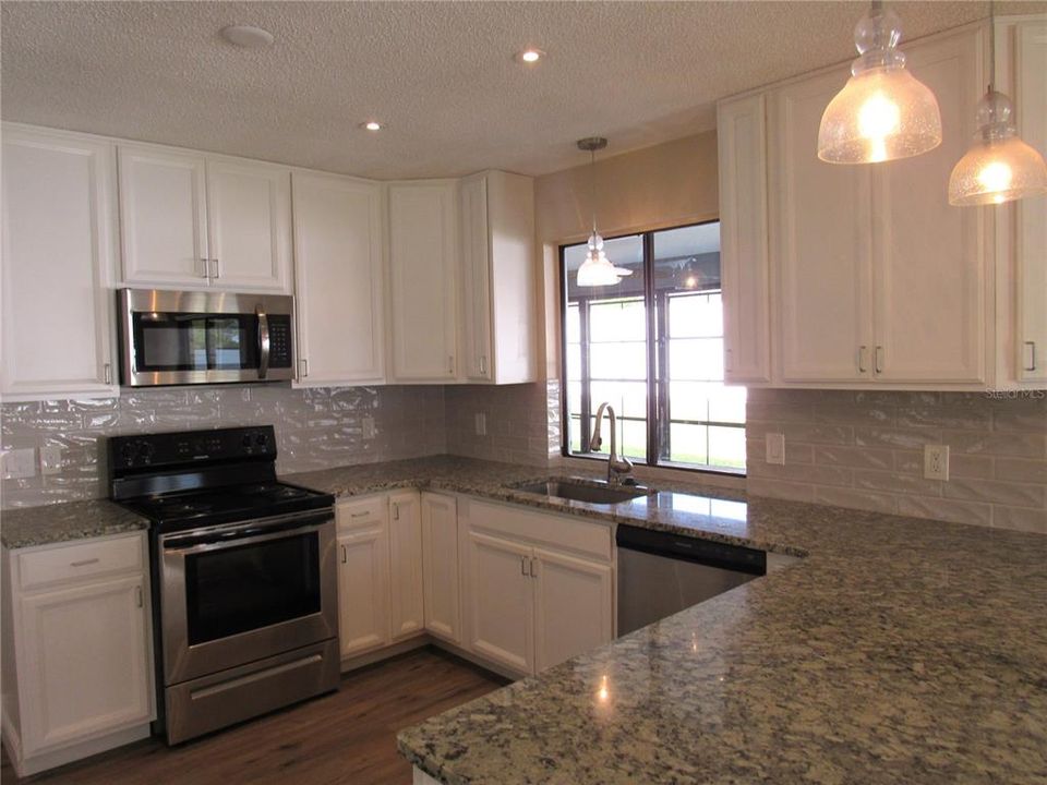 This Modernized Kitchen Is A Person's Dream Kitchen Beautiful & Functional w/ Serving Window To Lanai!
