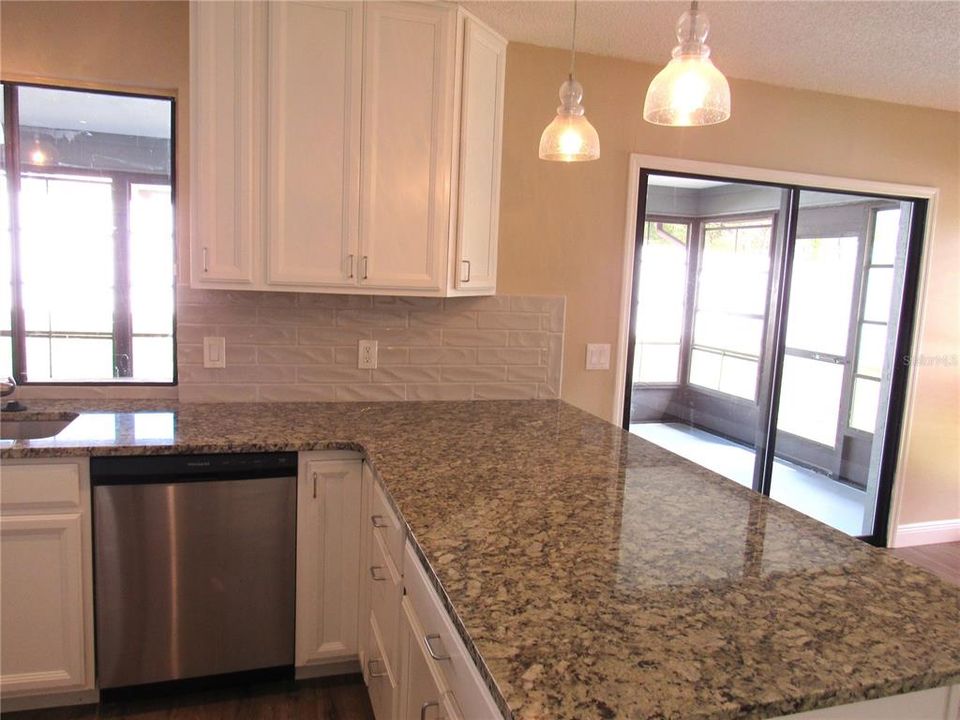 Beautiful Granite Counter Tops and White Classy Kitchen Cabinets Make This a Wow Culinary Kitchen!