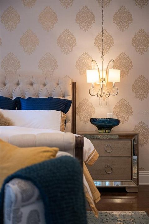 Snapshot of the Primary Bedroom with elegant papered accent wall