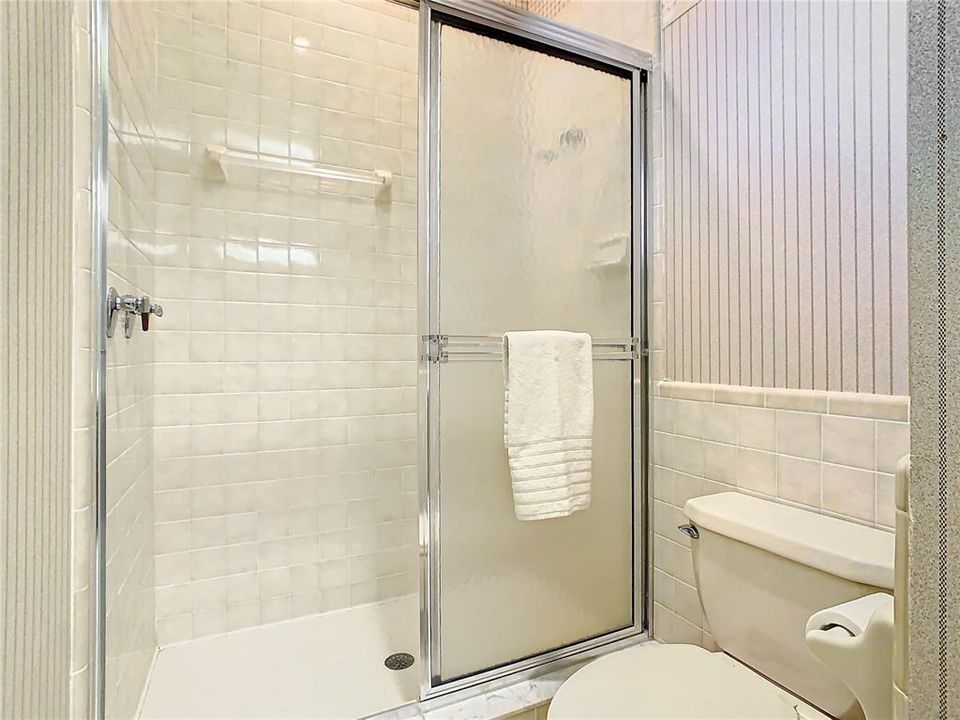 Upstairs guest bath has walk-in shower.