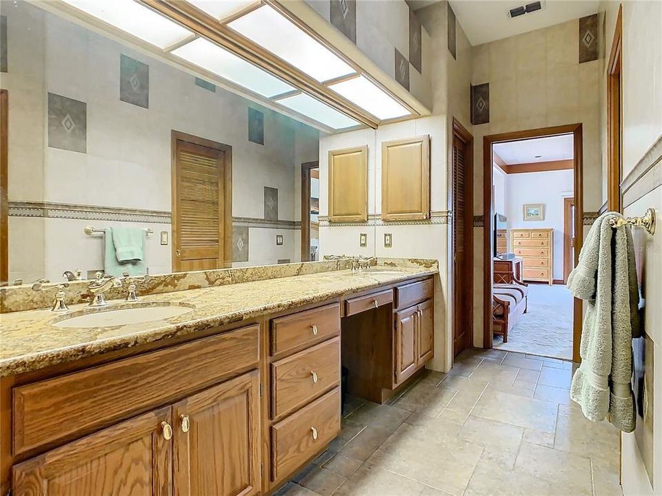 en-suite luxury bathroom with a large vanity and double sinks