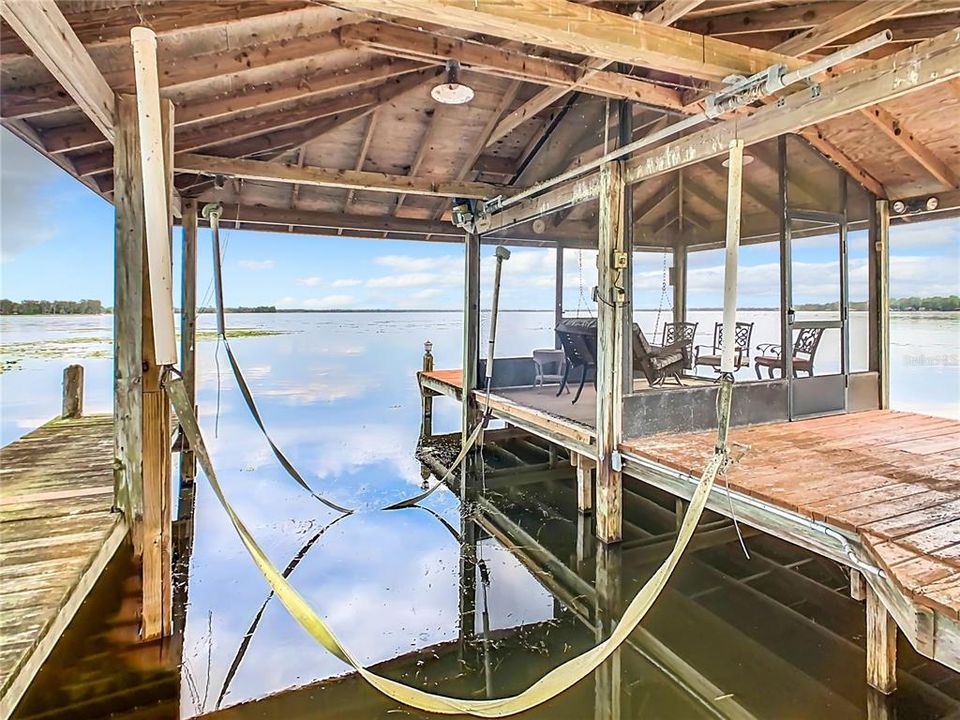 Boat house with lift.  There is water & electric to the dock.