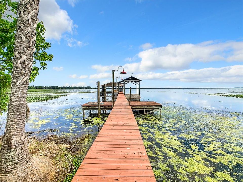 Dock, boat house and lift with electric and water and a screened in porch at the end of the dock.