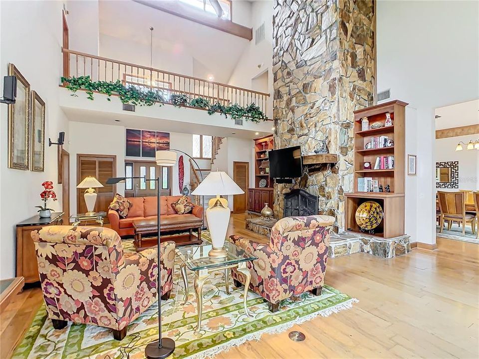 Stone wood-burning fireplace with built-in book cases on either side.