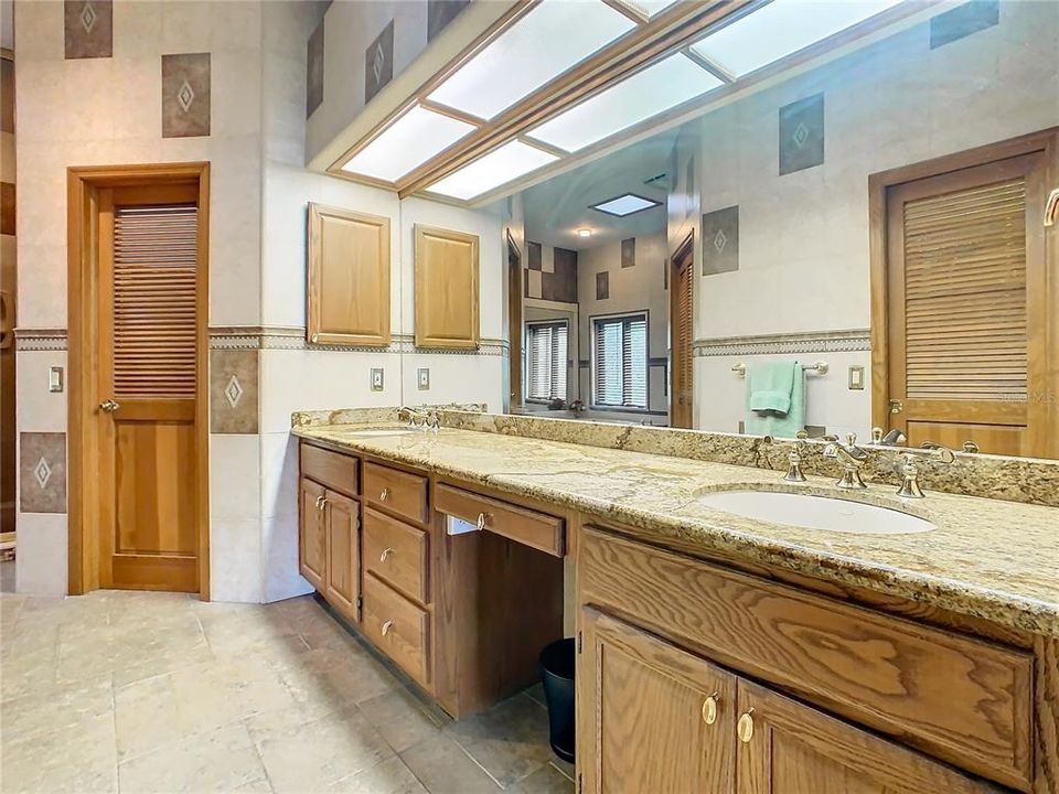 en-suite luxury bathroom with a large vanity and double sinks