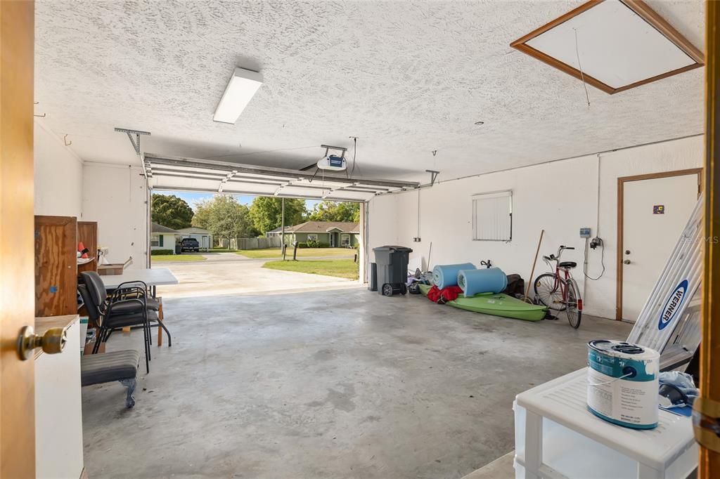 THIS OVERSIZED GARAGE HAS A WORKSHOP AREA AND PULL-DOWN ATTIC STAIRS FOR EVEN MORE STORAGE OPTIONS