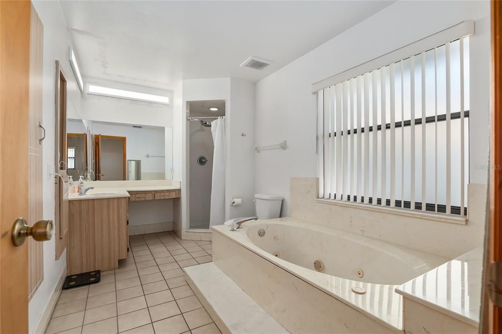 THE MASTER BATH HAS BOTH A WALK-IN SHOWER AND A GARDEN TUB