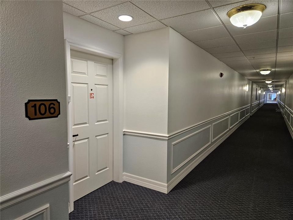 View 1st floor corridor and entrance to unit 106