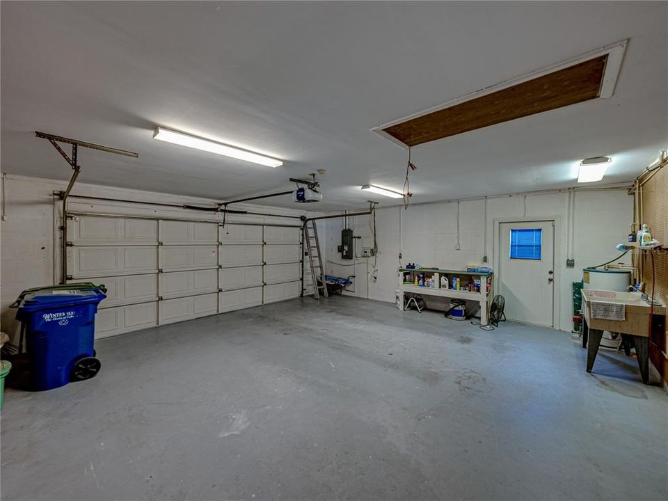 OVERSIZED GARAGE WITH EXTERIOR DOOR AND DOUBLE LAUNDRY TUB