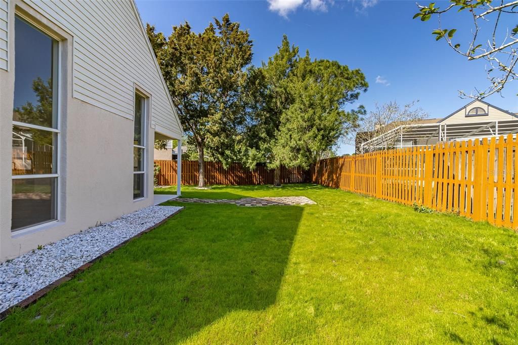 Covered lanai and gorgeous PAVED BACKYARD presenting a picture-perfect setting for relaxation and entertainment