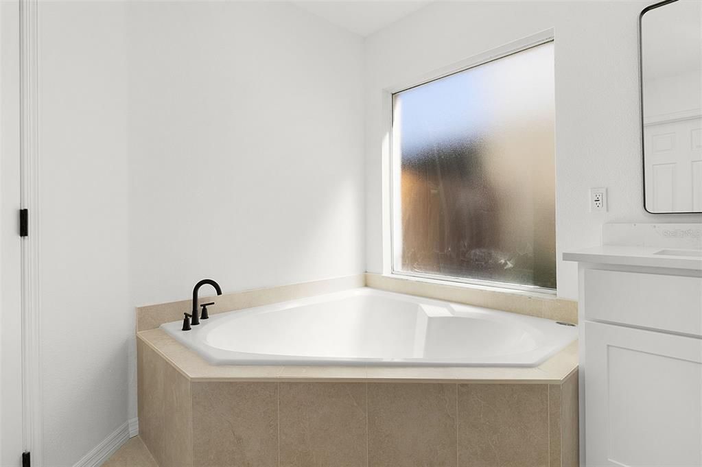 OWNER BATHROOM with GARDEN TUB, a Great sized SHOWER, DUAL SINKS with QUARTZ COUNTERTOPS, and a separate walk-in CLOSET