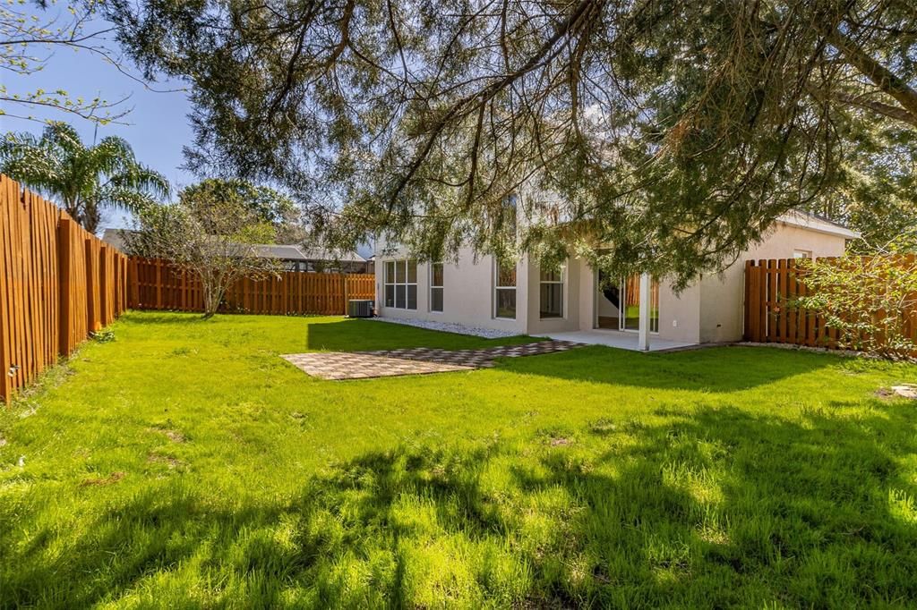Covered lanai and gorgeous PAVED BACKYARD presenting a picture-perfect setting for relaxation and entertainment