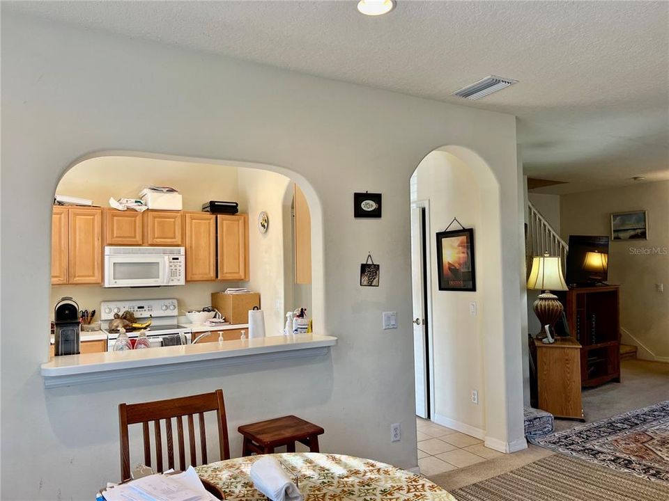 Kitchen pass through with area for stools to eat at counter.