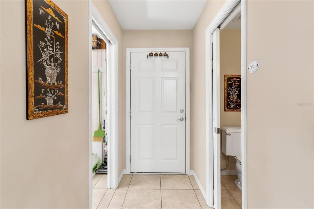 Hallway leading to Garage, Laundry Room, and Guest Half Bath