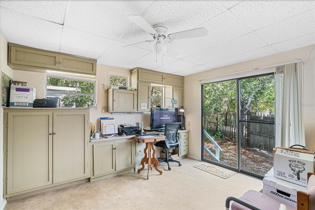 Office with sliding door out to backyard