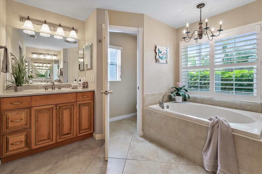 Primary Bath features double sinks, a garden tub, walk-in shower and private water closet