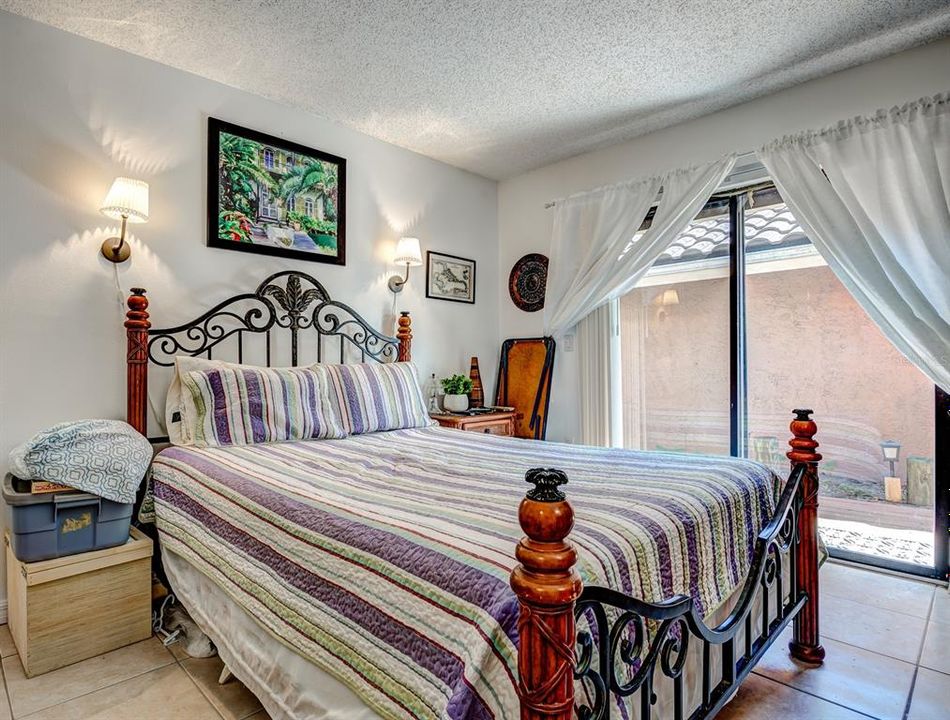 Bedroom 2 features a walk-in closet and glass sliding doors to its outside deck.