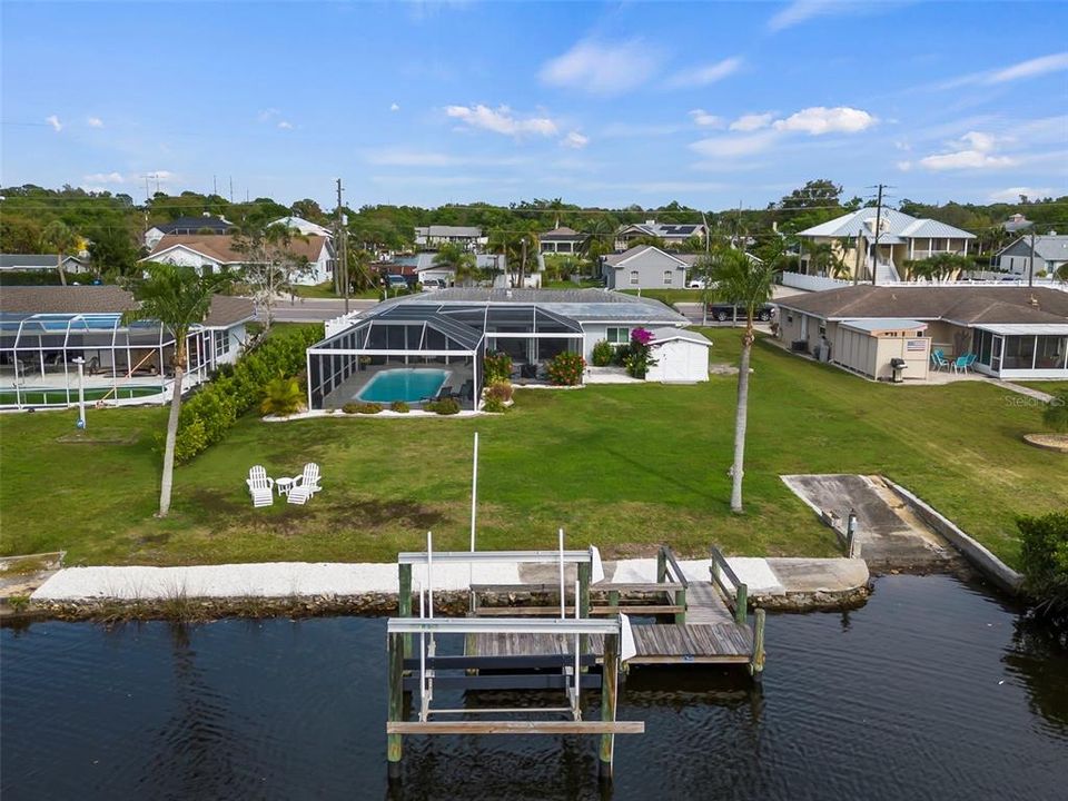Overview of home, seawall, dock, lift and boat ramp