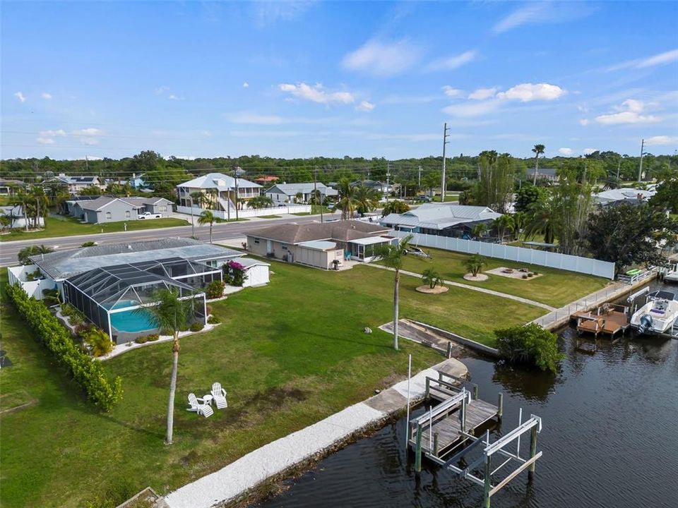 Aerial of home, seawall, lift, dock and boat ramp