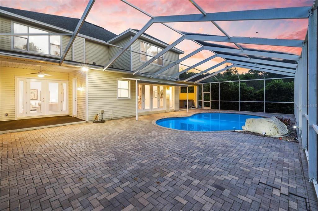 Lovely screened in pool area with patio space.