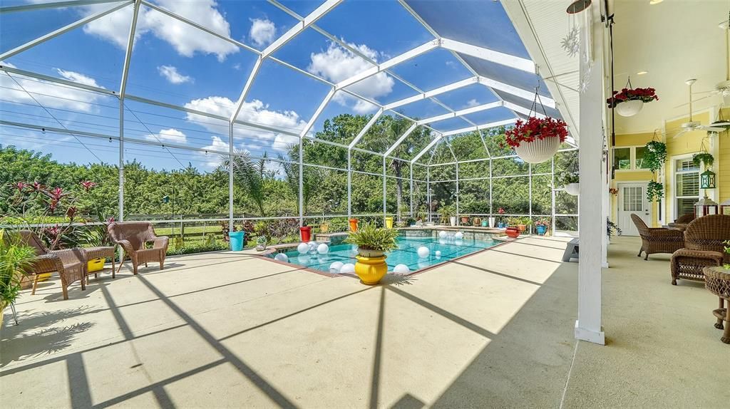 Enjoy relaxing on the screened lanai with covered area and watching the family play in this very large swimming pool with a spa attached.  Heater has never been used and is not warranted.