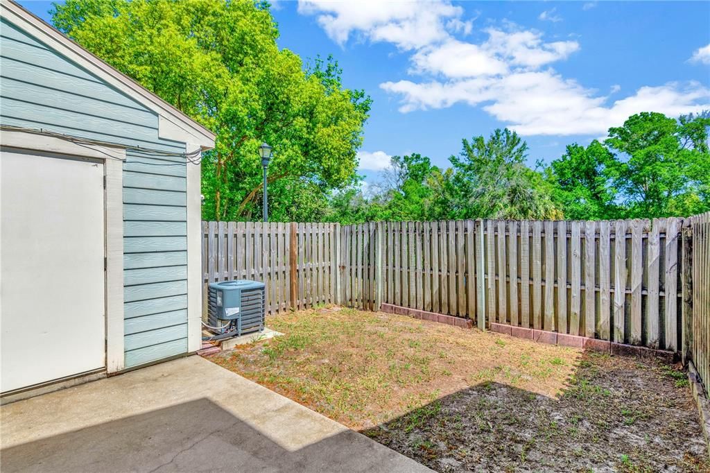 Private fenced backyard with large storage closet