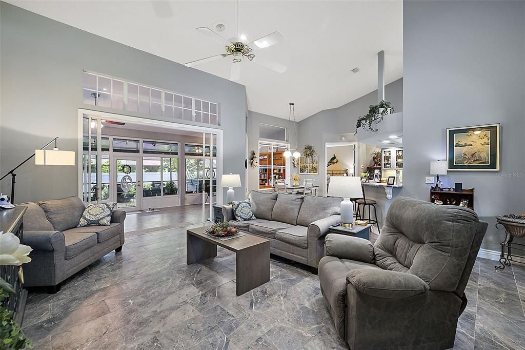 Family room with French sliding doors that lead to the light infused lanai