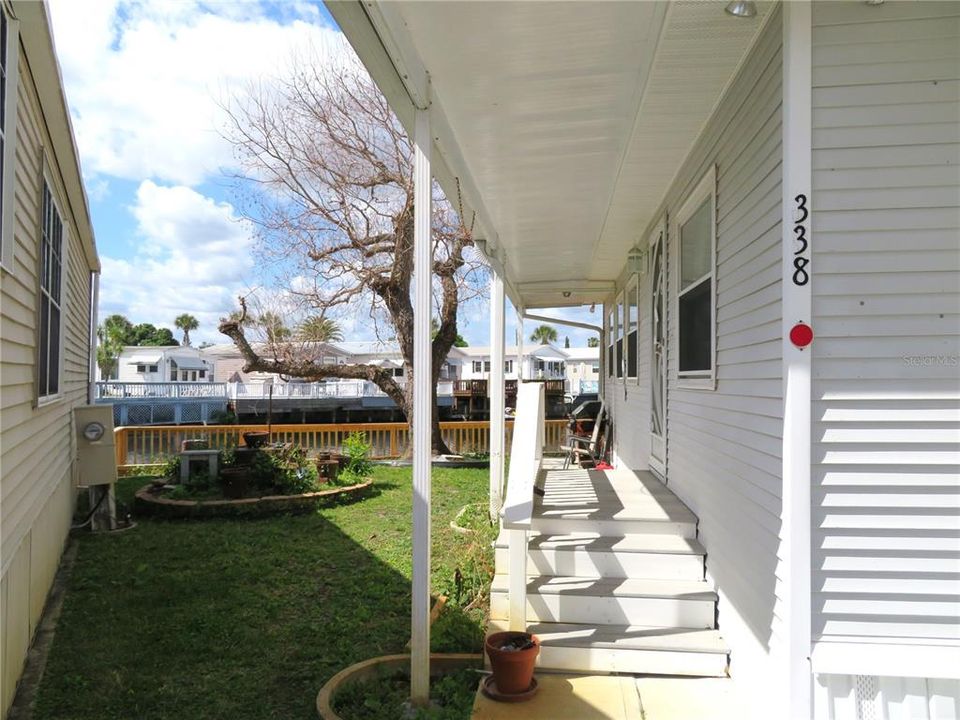 Covered side porch  and steps leading into the unit