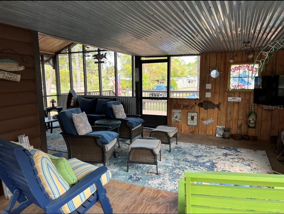 Large screened-in porch with 65 inch TV