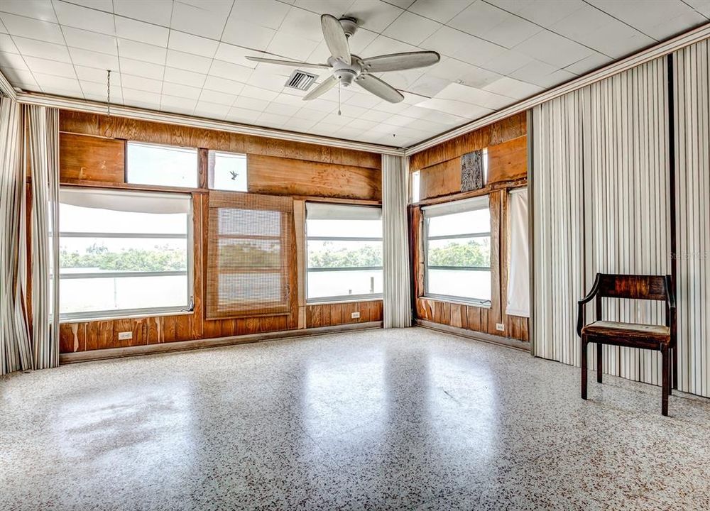 The back Florida room with terrazzo floors and nothing but views of the water.