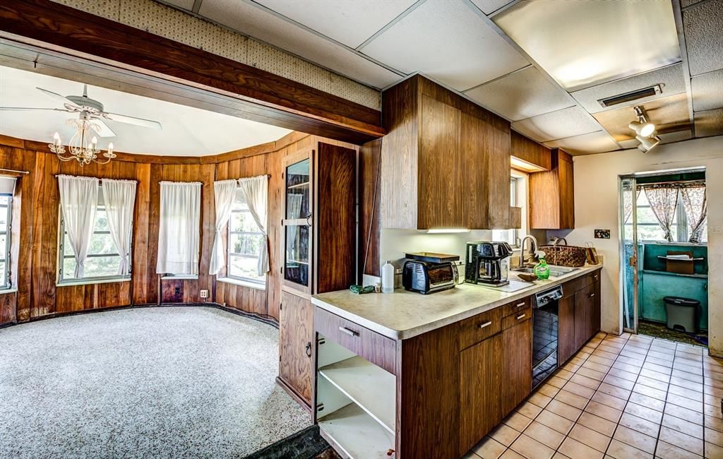 The kitchen and large dining room with terrazzo floors.