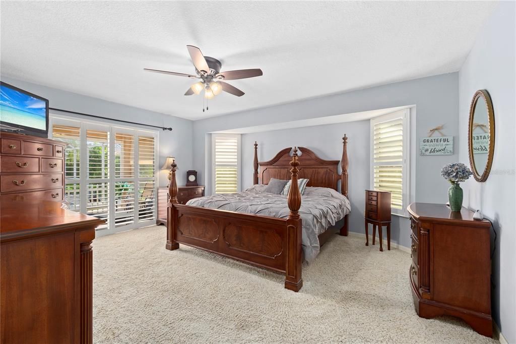 Master Bedroom.  Plantation Shutters on sliders to the lanai.  Freshly Painted.