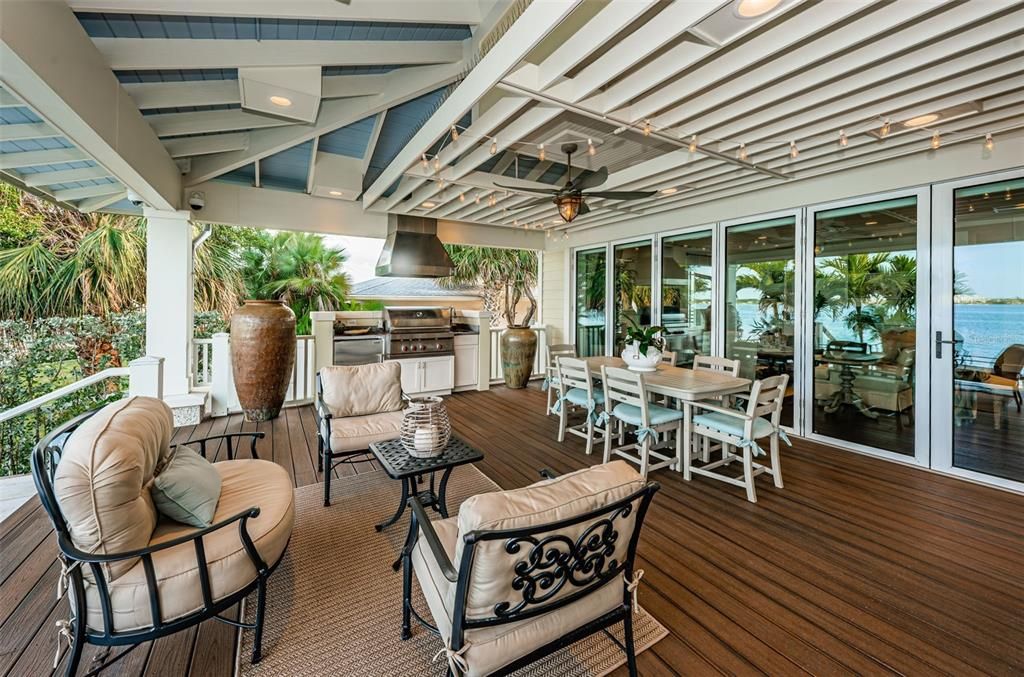Such a great outdoor space, right off your Family Room!  The Hurricane rated glass doors accordion open to bring inside out, a phenomenal feature to entertain & enjoy your expansive outdoor space!