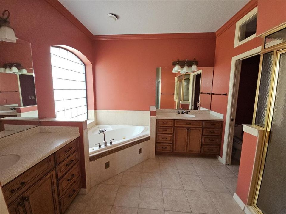 Primary Bathroom - With Two Vanities, Tub, Private Toilet Closet and Step-In Shower.