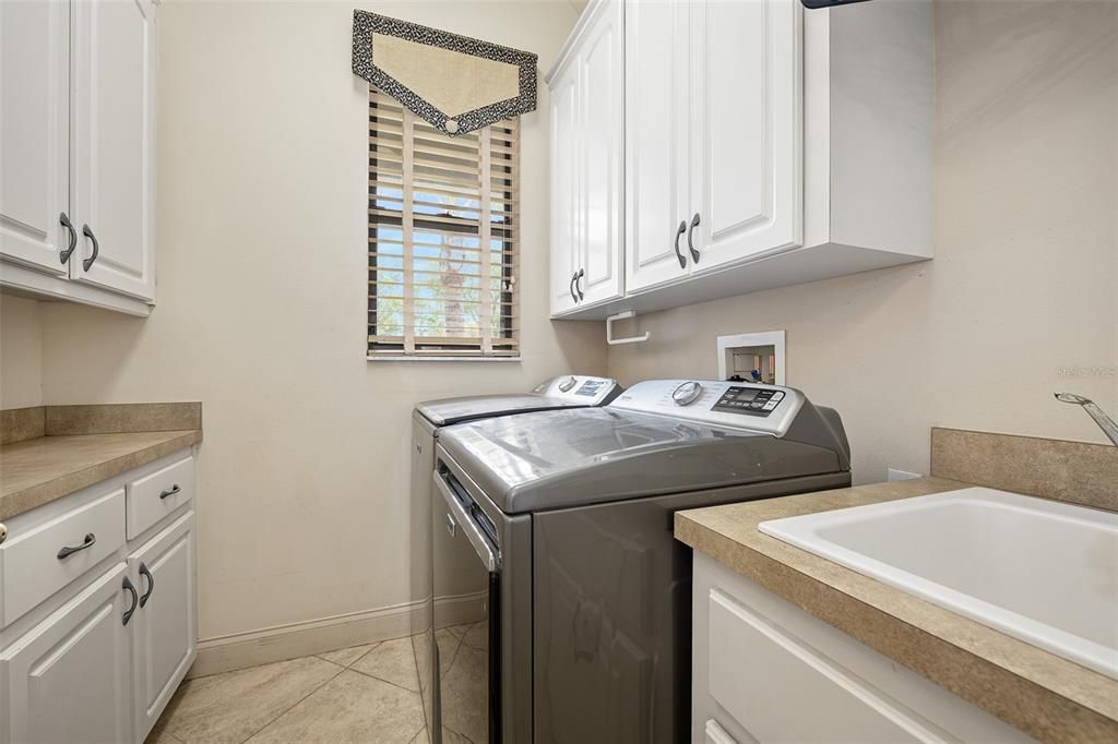 Inside laundry with sink and storage