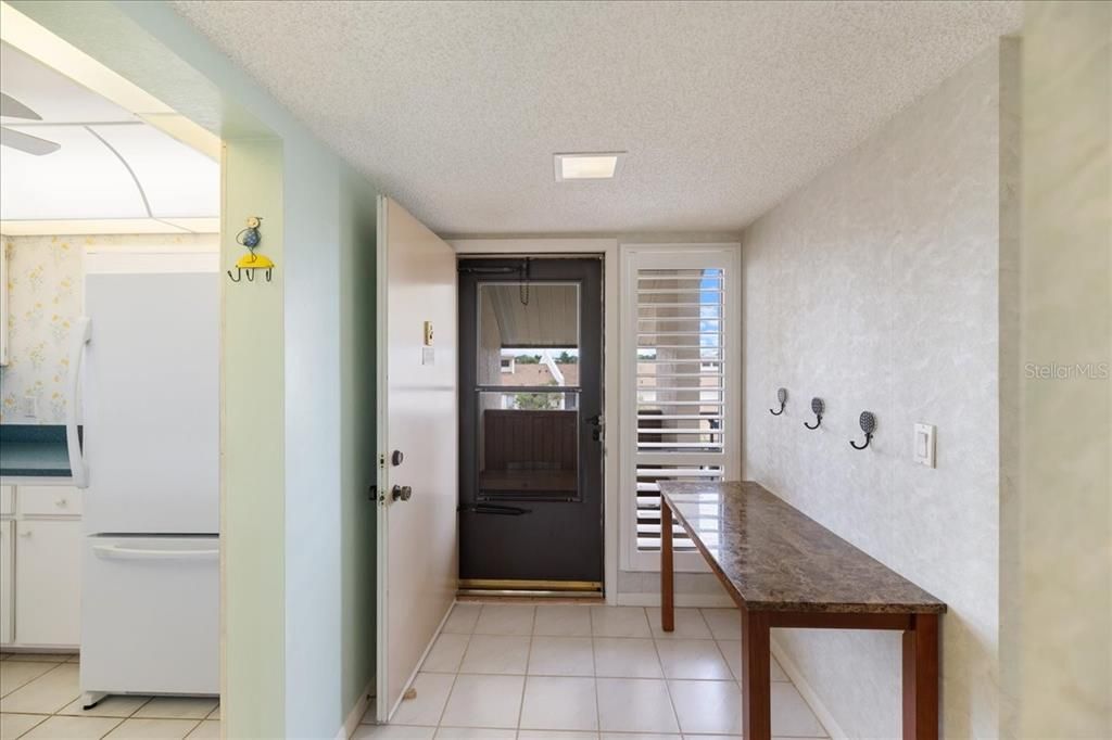 front door. The unit has plantation shutters in kitchen and foyer