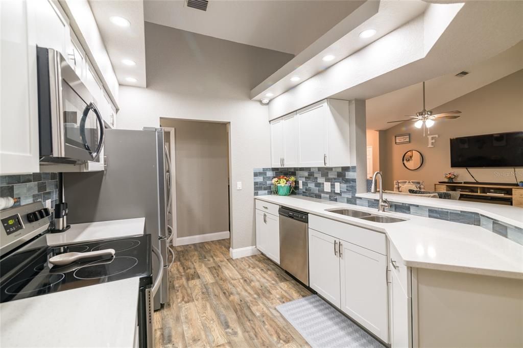 Kitchen features wood cabinets and granite counters.