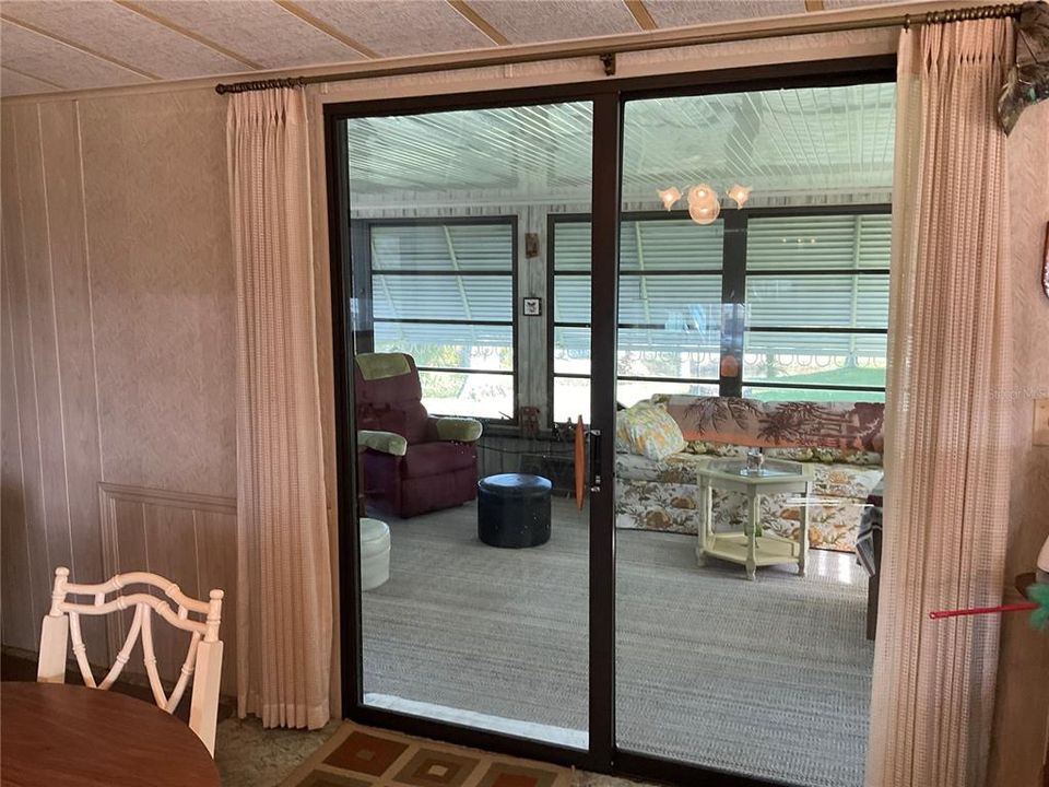 Sliding glass door off dining room out to Florida room