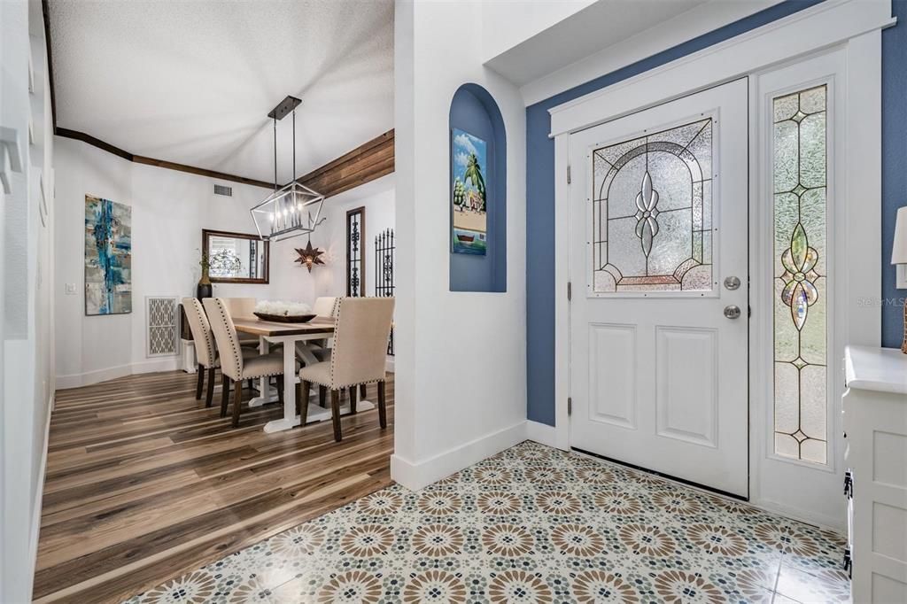 Front Entry, Gorgeous New Tile Flooring and New Water-Resistant Laminate Flooring in the Dining Room along with custom crown molding.