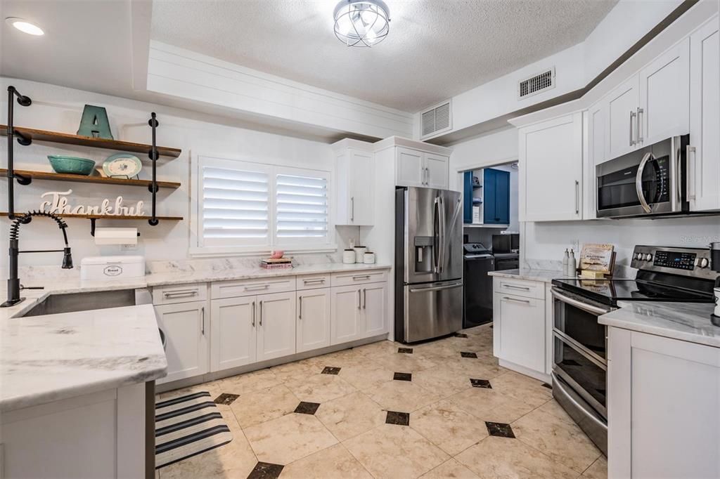 Chef's Kitchen!  Counter Tops, New faucet, New Fixture and newer appliances Farm sink, open storage bar area between dinette area and family room along with a Shiplap Bulkhead.