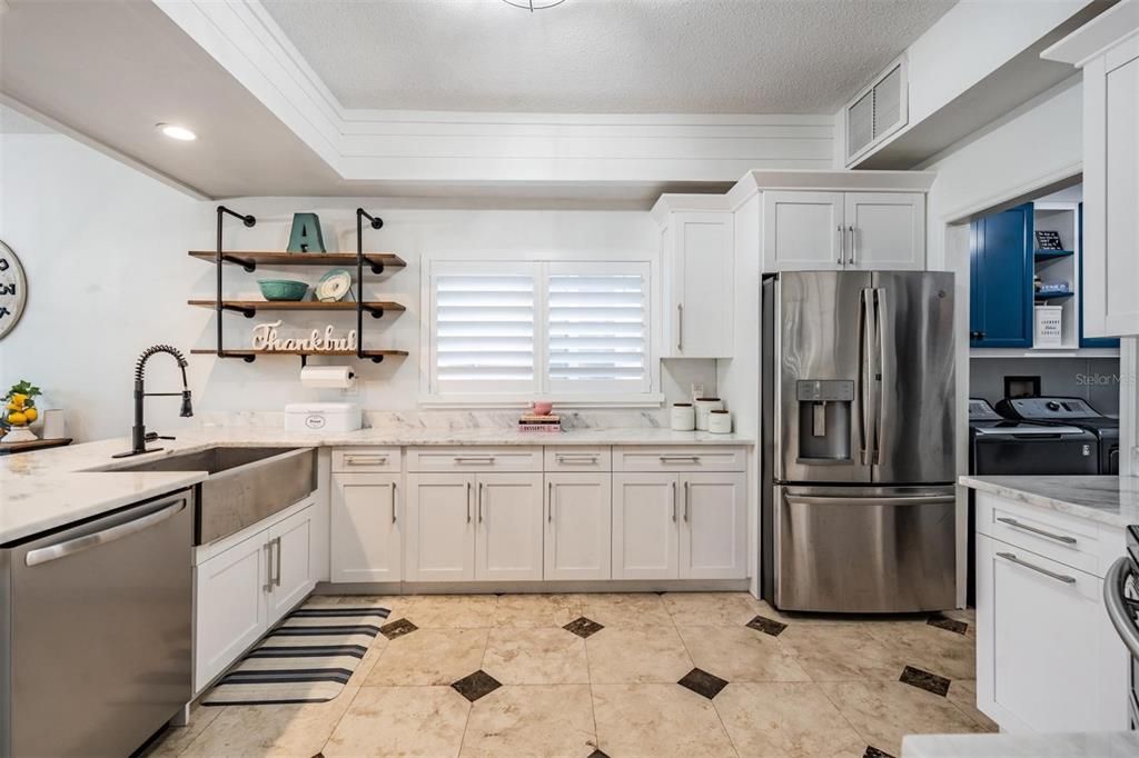 Marble Counter Tops, New faucet, New Fixture and newer appliances Farm sink, open storage bar area between dinette area and family room along with a Shiplap Bulkhead.