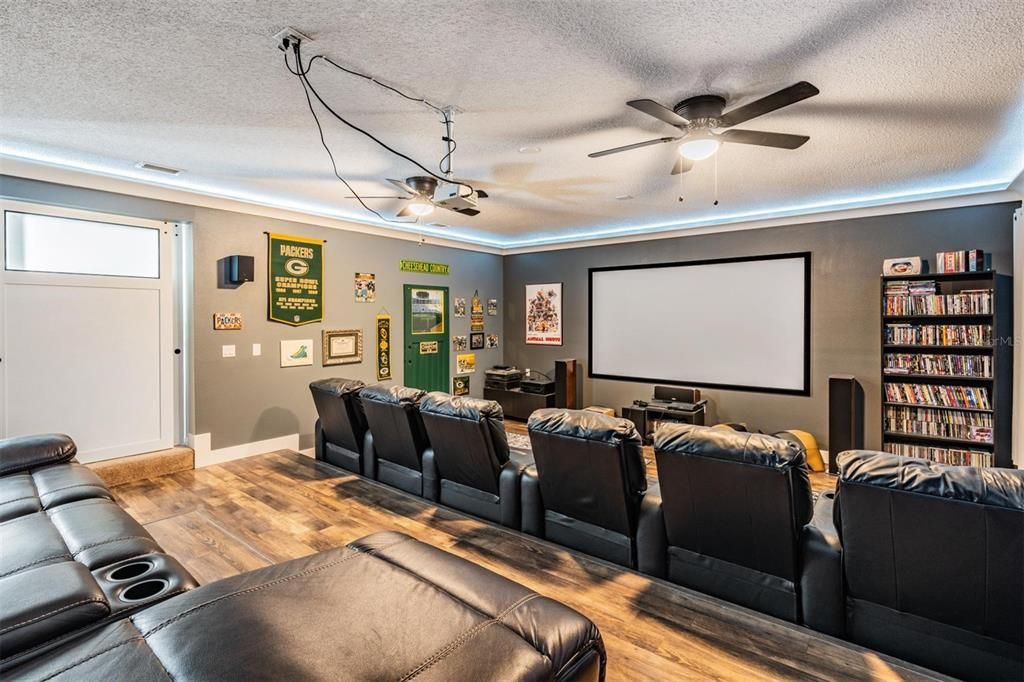 Huge Theater Room, New Water-Resistant Flooring, Black-out window curtains, ceiling fans and full bar area, up lights surrounding to tray ceiling,Remodeled space with tiered flooring to accommodate seating for 10, Surround lighting and 100 Viewing Screen
