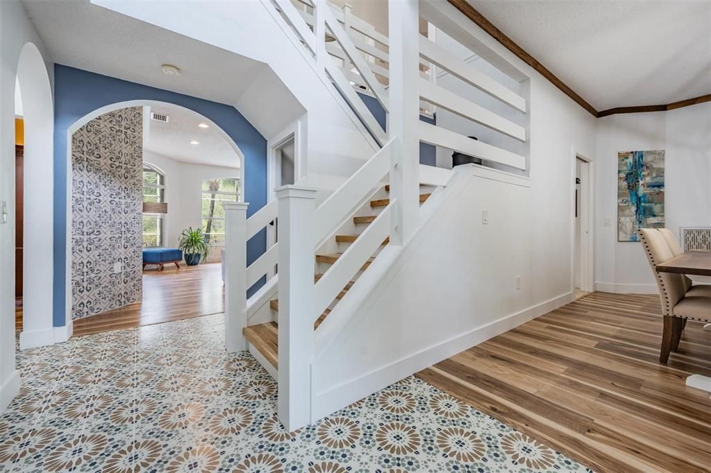Front Entry, Custom Horizontal Stair Railing stair treads with solid wood nosing, New Tile Flooring and New Water-Resistant Laminate Flooring in the DR along with custom crown molding.