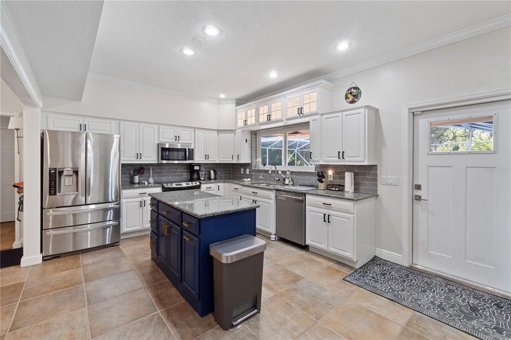 Step into a fresh and clean white kitchen adorned with granite countertops, complemented by the addition of a brand new Bosch dishwasher, offering both elegance and functionality.