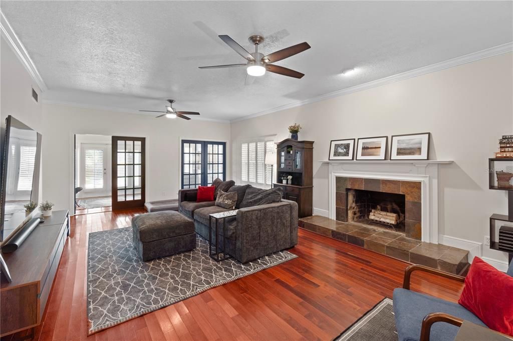 The first floor also showcases a cozy living room, complete with a wood-burning fireplace and luxurious, rich hardwood floors.