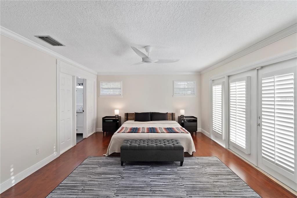 The primary bedroom features warm hardwood floors, a spacious walk-in closet, and an en suite master bathroom. French doors open to a landing pad, offering the possibility of your own personal balcony retreat.