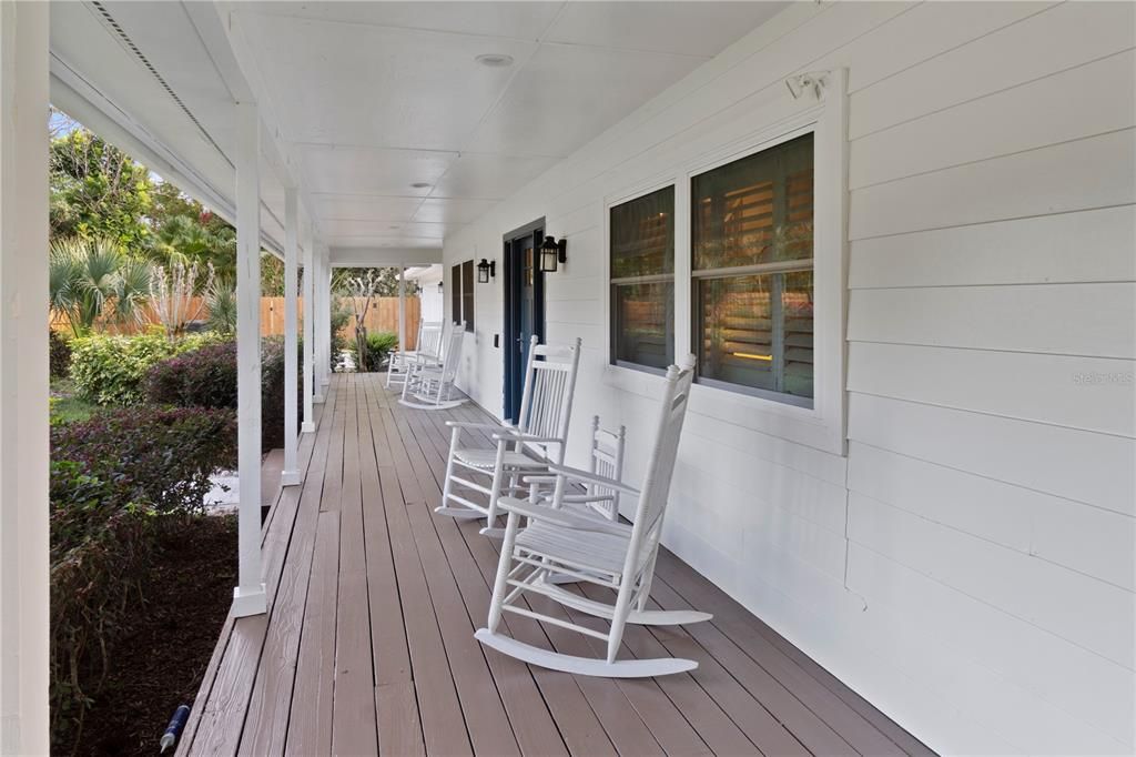 The front porch boasts a freshly painted, impeccably maintained appearance, mirroring the pristine condition of the landscaping.