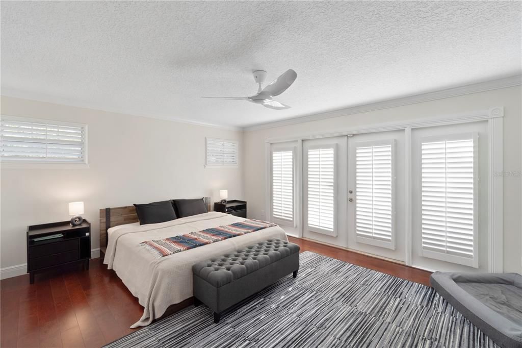 The primary bedroom features warm hardwood floors, a spacious walk-in closet, and an en suite master bathroom. French doors open to a landing pad, offering the possibility of your own personal balcony retreat.