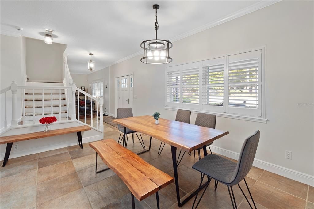 The dining room exudes charm with its plantation shutters and high-quality tile flooring, promising effortless maintenance and a touch of sophistication. Additionally, it features a staircase with a two-way landing pad, designed for optimal efficiency and convenience.