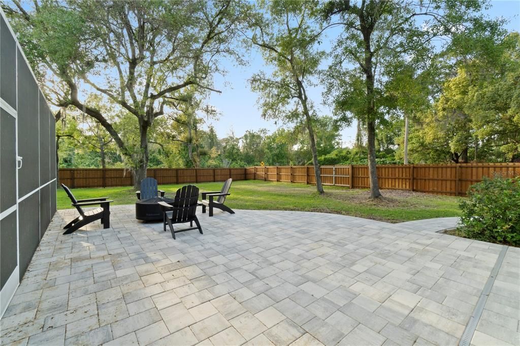 The new pavers seamlessly extend into the backyard, offering durable flooring for outdoor living.
